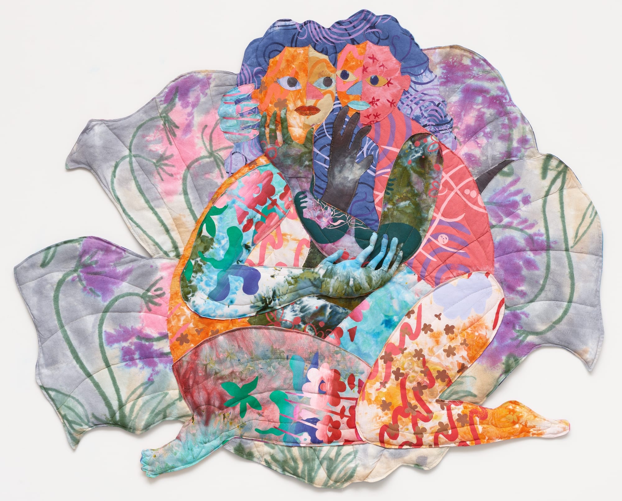 a textile portrait of two women in vivid, patterned fabrics