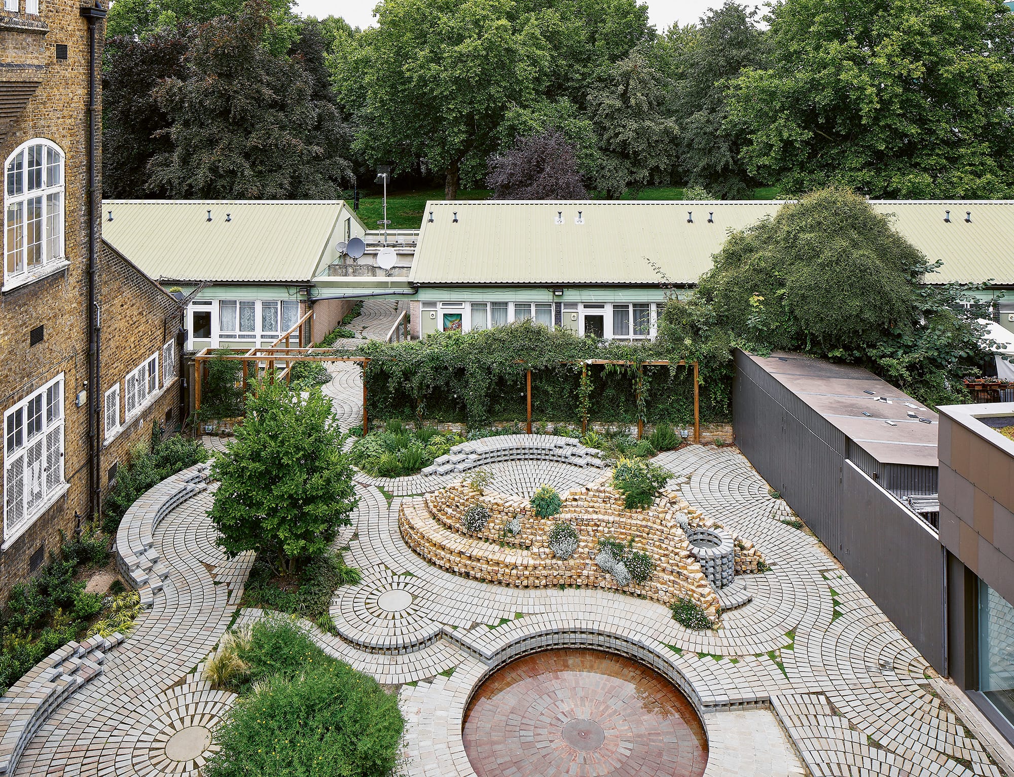 a largely tile and stone garden in a courtyard