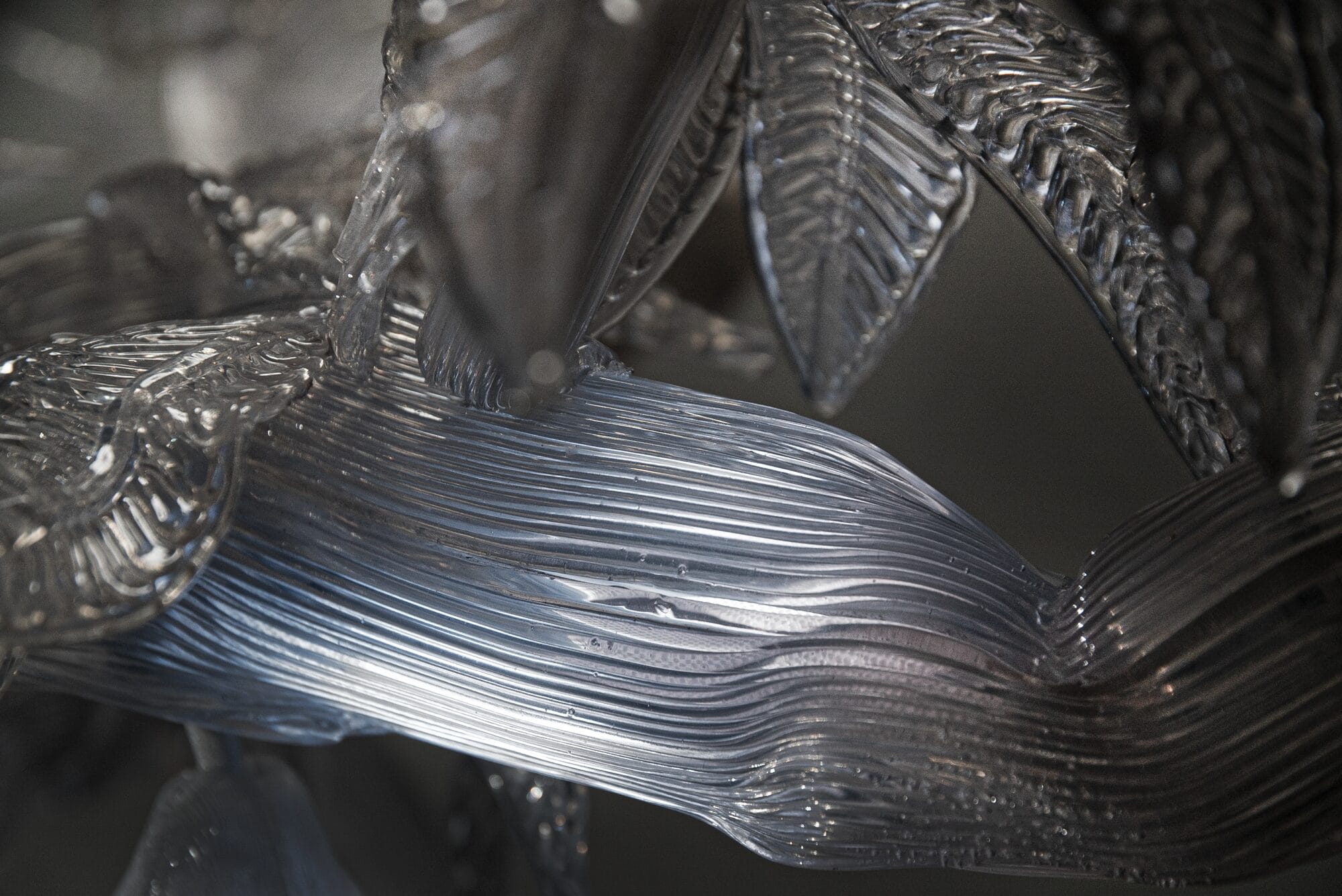 a detail of a sculpture of a clear, illuminated cacao tree